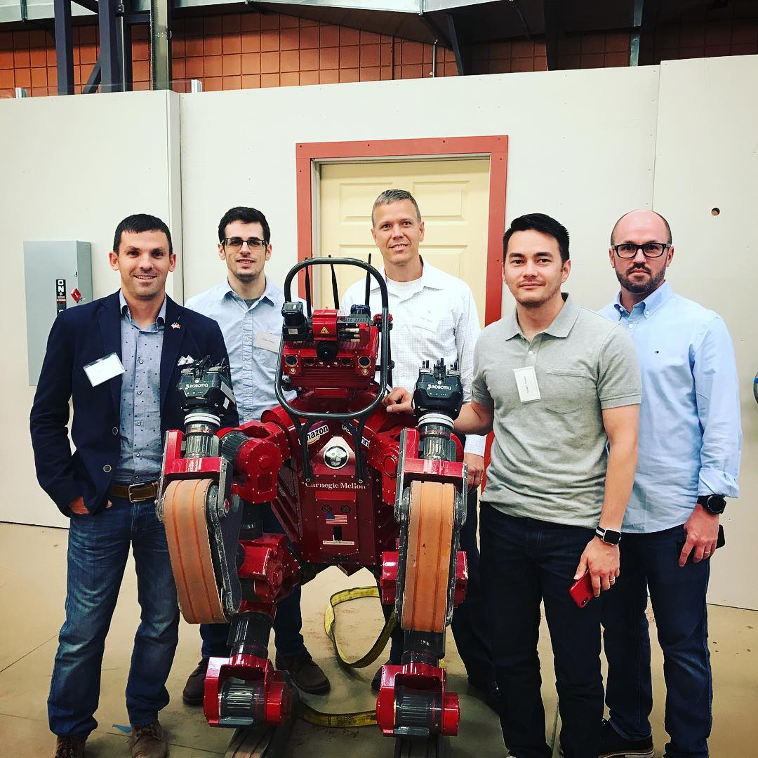 Peter with colleagues beside a Carnegie Mellon robotics platform.